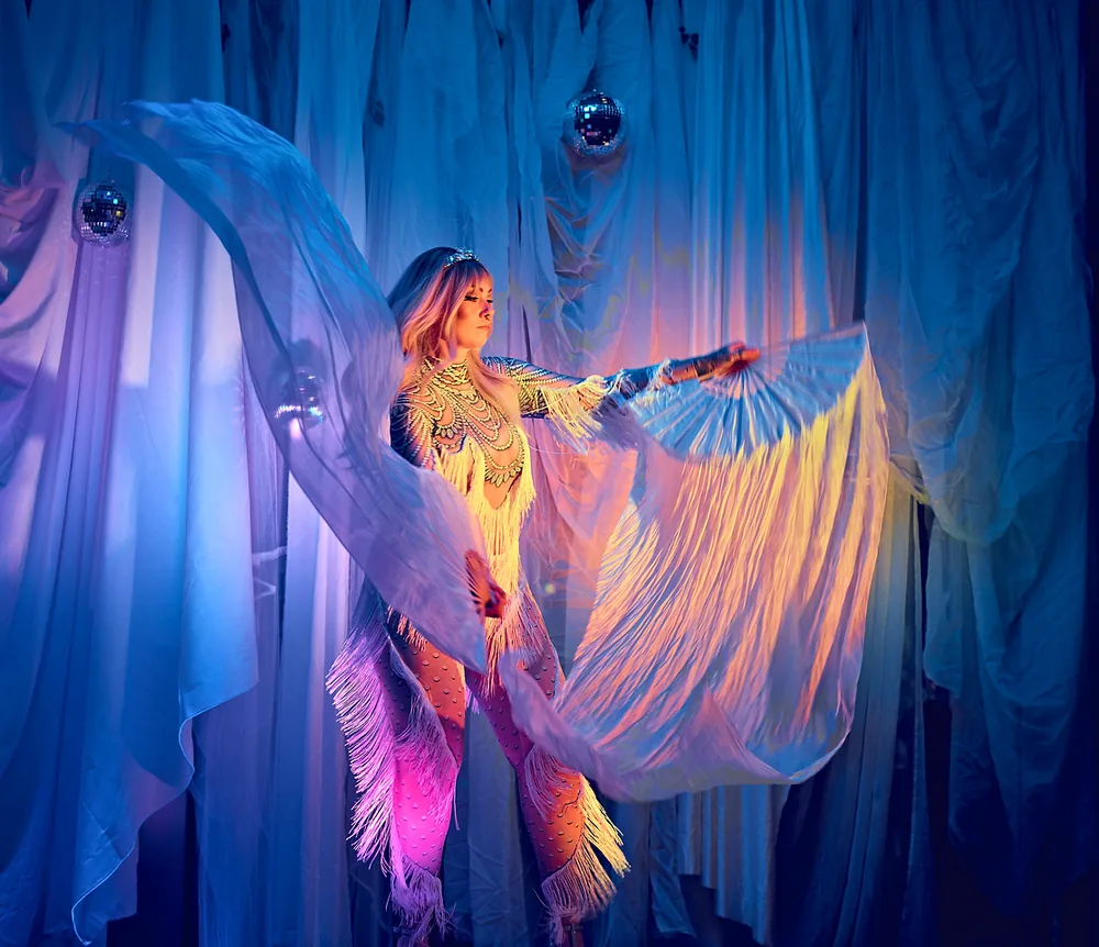 Dancer with large feather fans