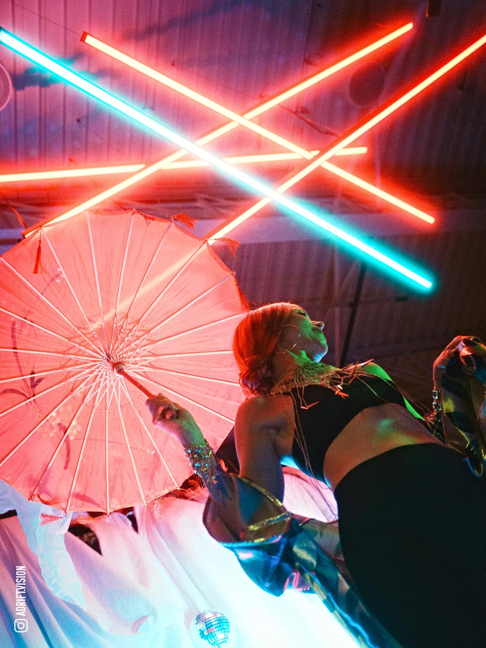 Parasol under crossed neon lights