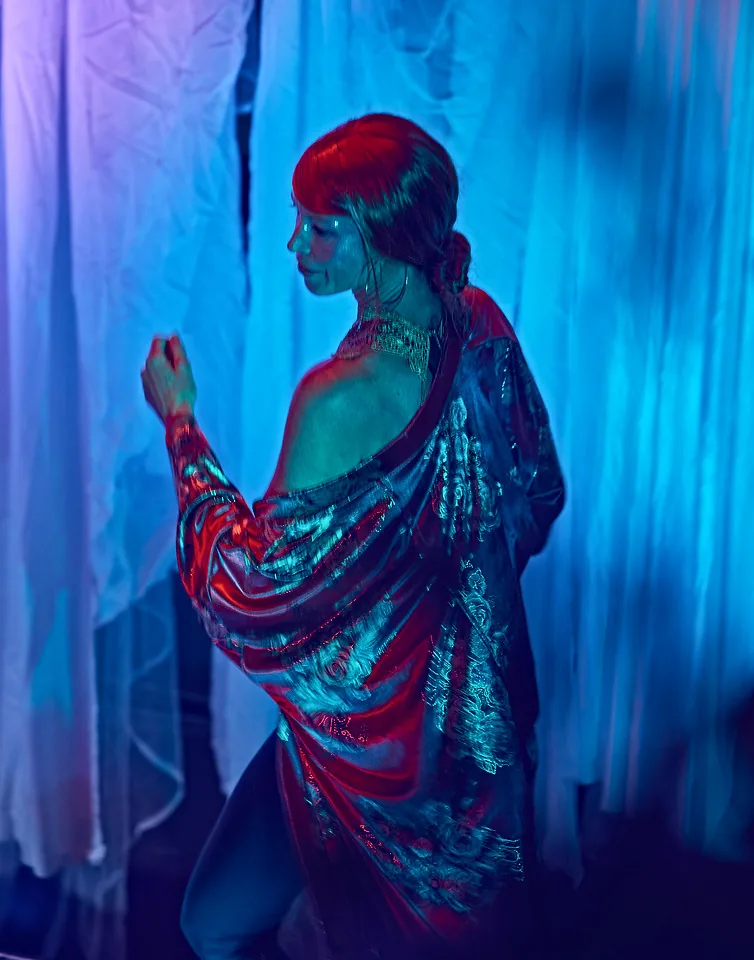 Robe draped off the shoulder in blue light