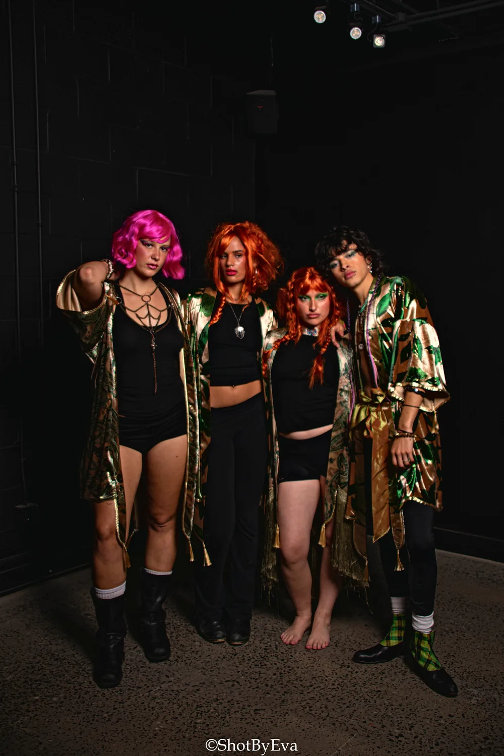 Four models in gold and green robes